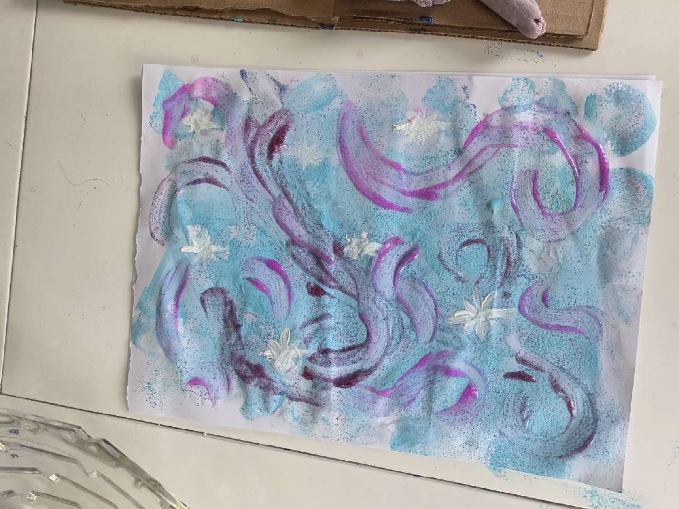 A swirling blue and purple abstract painting made by a child